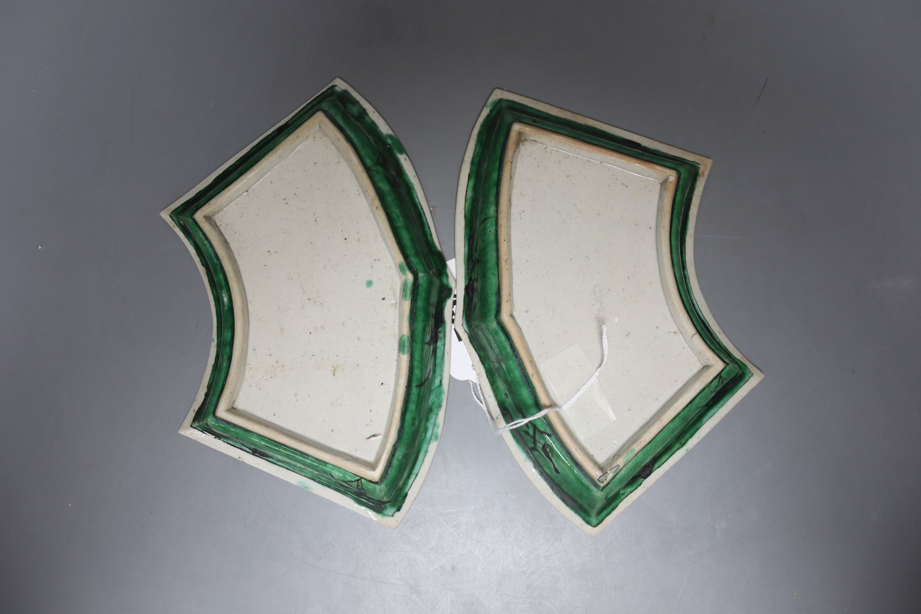 A pair of Chinese famille verte biscuit fan-shaped sweetmeat dishes, Kangxi, 20 cms wide.